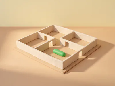 Une maquette de plan d’appartement en pâte, une pilule verte posée dans une pièce.