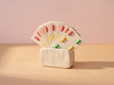 Un porte-cartes en pâte rempli de fiches, chacune marquée d’une pilule de couleur.