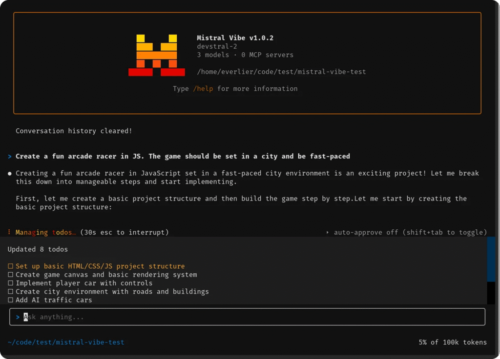 Interface de terminal Mistral Vibe créant un jeu d'arcade en JavaScript.